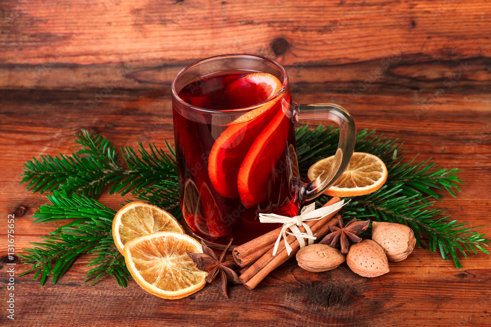 mulled wine with chritsmas spices over dark wood
