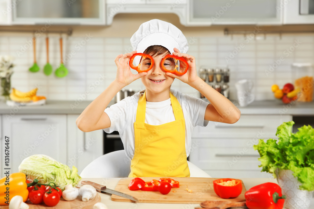 Cute boy cooking in kitchen at home Cute boy cooking in kitchen at home