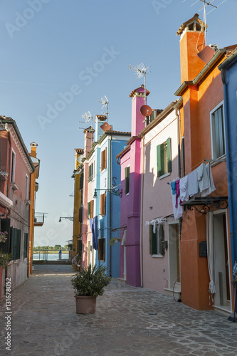 Narrow Mediterranean style street on Burano island, Italy.