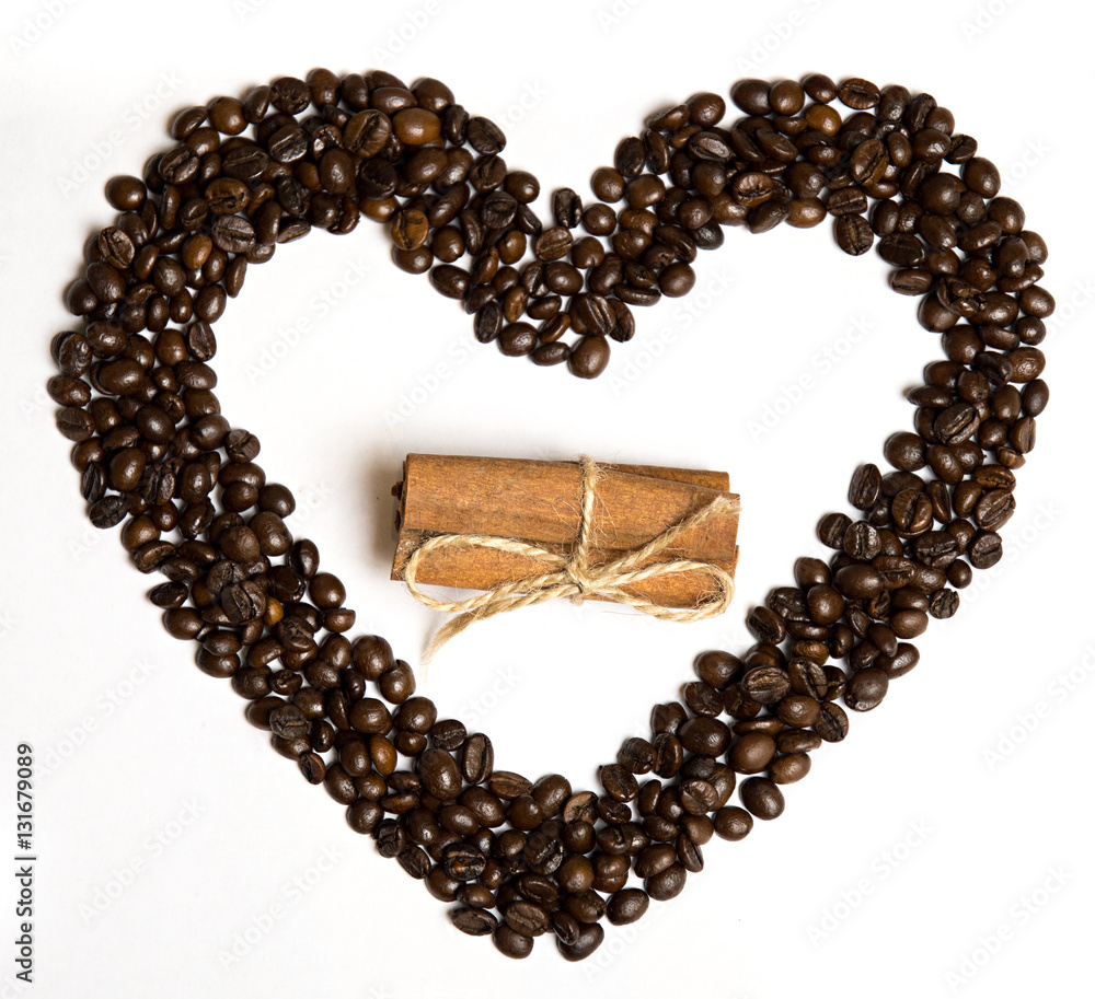Coffee beans in heart shape and cinnamon in the center Coffee beans in heart shape and cinnamon in the center
