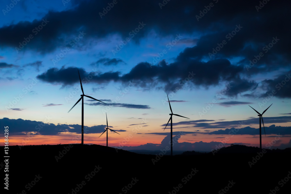 Obraz premium wind turbine sunset time, silhouette