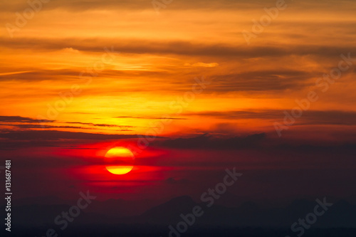 Sunset in clouds over red sunset sky background. © bubbers