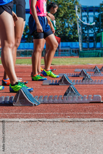 Runner feet on track -sprint start in track.