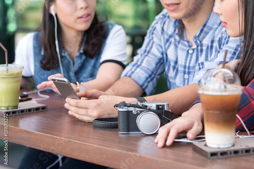 three people using smartphone in coffee shop, internet of things