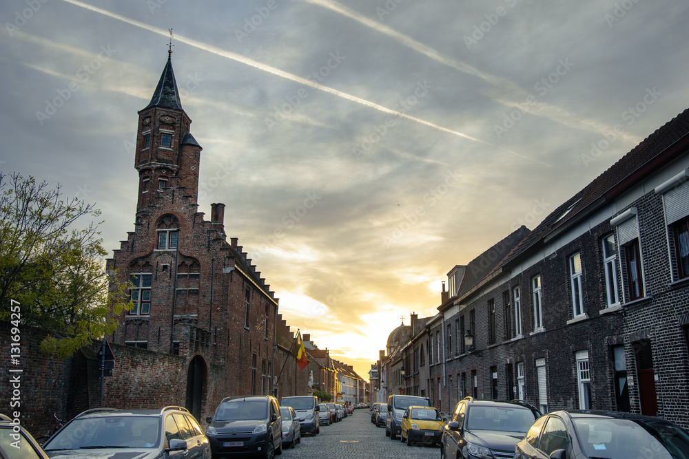 Street and medieval church in Bruges, Belgium