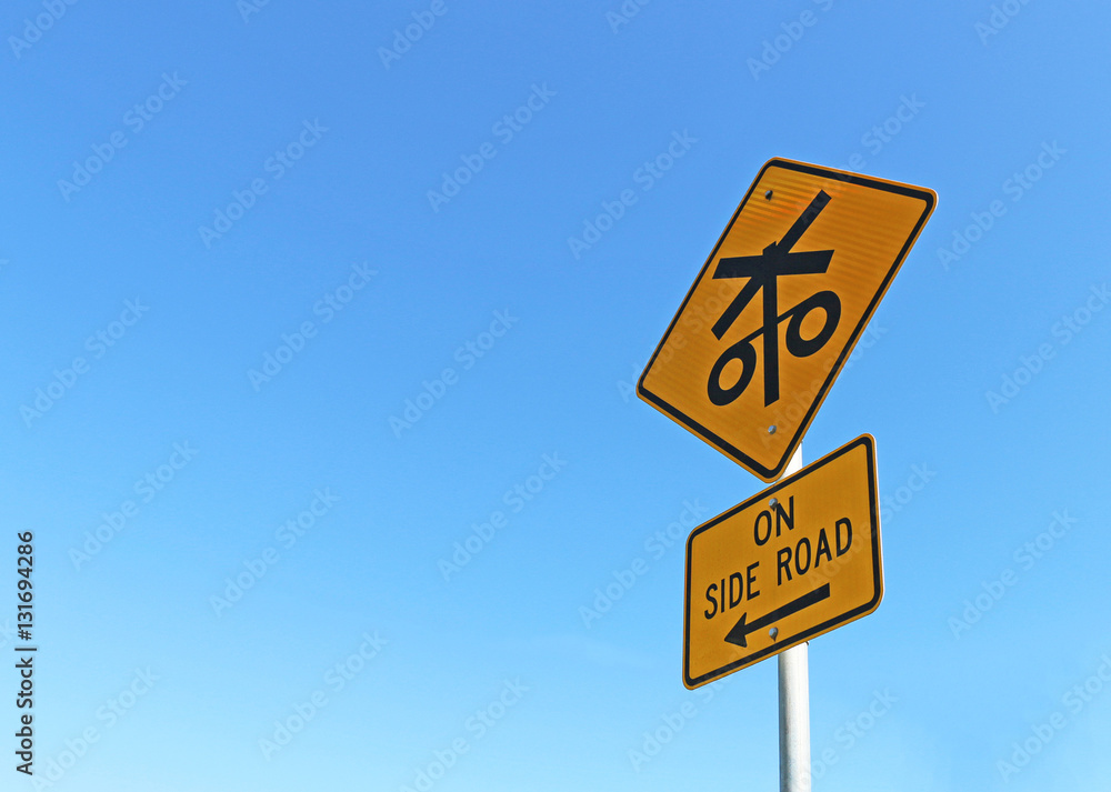 black and yellow trains on side road sign in bright blue cloudless sky black and yellow trains on side road sign in bright blue cloudless sky