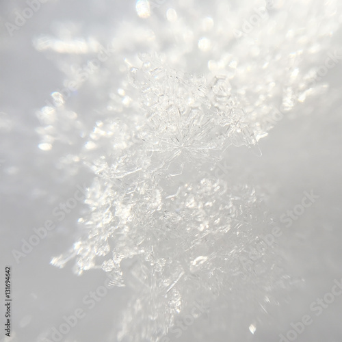snowflakes close-up on white glitter bokeh background