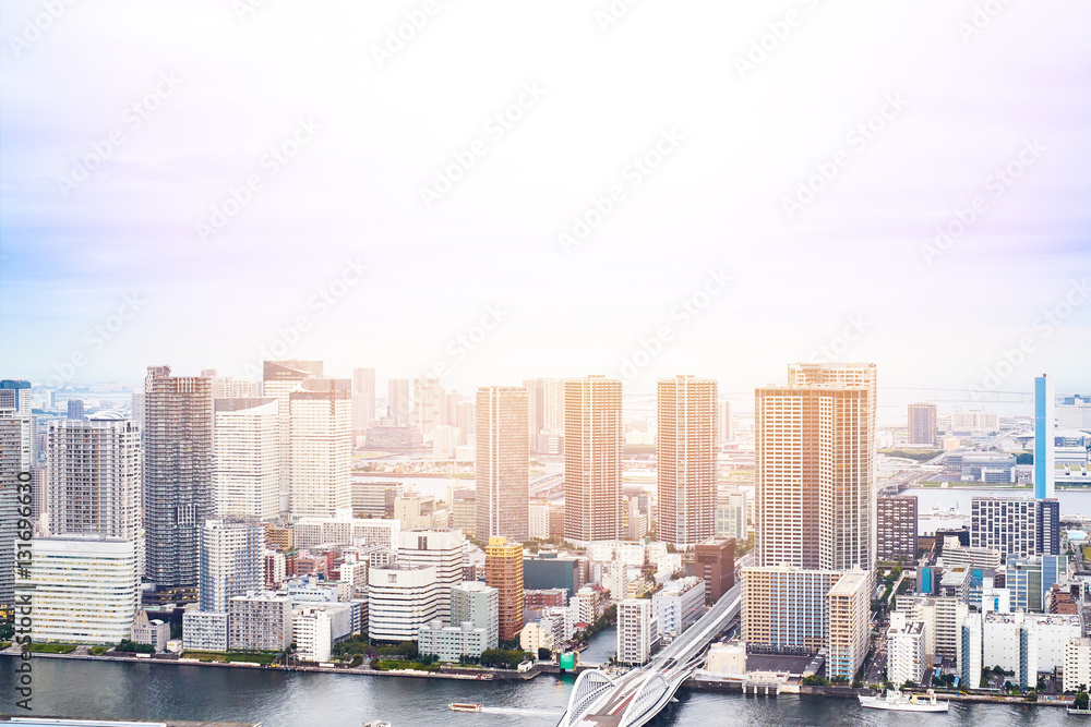 Asia Business concept for real estate - panoramic modern cityscape building bird eye aerial view of Odaiba bay and rainbow bridge under sunrise and morning blue bright sky in Tokyo, Japan.