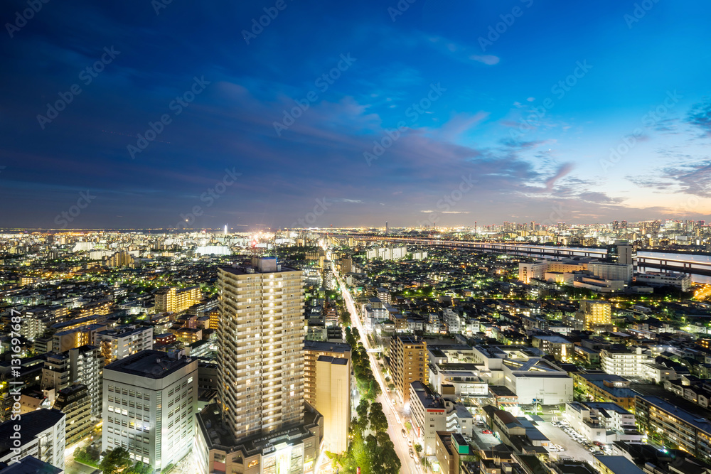 Fototapeta premium Business and culture concept for real estate and corporate construction - panoramic modern city skyline bird eye aerial night view under dramatic neon glow and beautiful dark blue sky in Tokyo, Japan