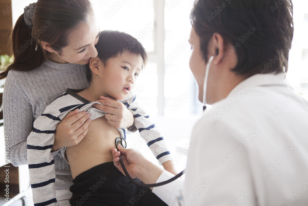 The boy is undergoing a screening in the pediatric department The boy is undergoing a screening in the pediatric department