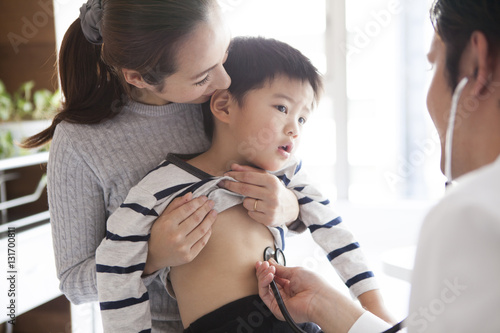 The boy is undergoing a screening in the pediatric department