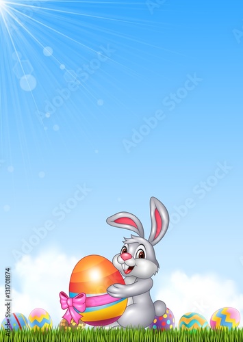 Cute little bunny holding easter egg     © tigatelu