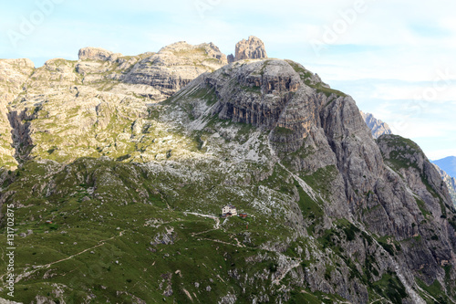 Mountain panorama and alpine Hut Zsigmondyhütte in Sexten Dolomites, South Tyrol, Italy photo