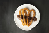Traditional Spanish churros with chocolate on black background w