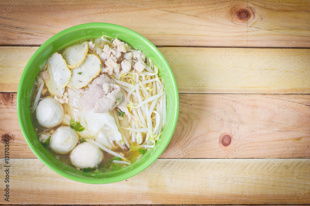 Noodles in green bowl on wood background. Noodles in green bowl on wood background.