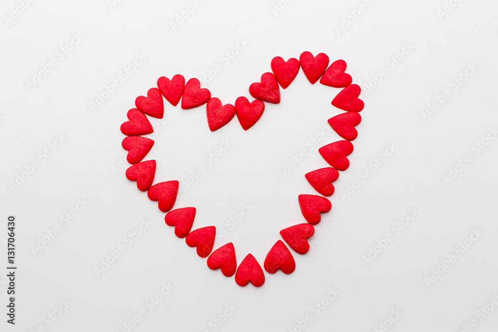 red heart made of small hearts on a white background. festive background for birthday, Valentine's day, wedding, celebration.
