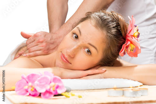 girl with flowers in her hair on a massage table from a professi