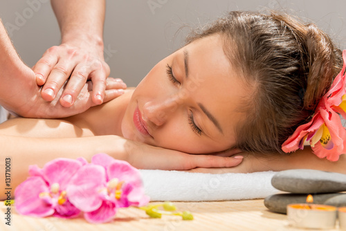 masseur's hands doing massage shoulder woman