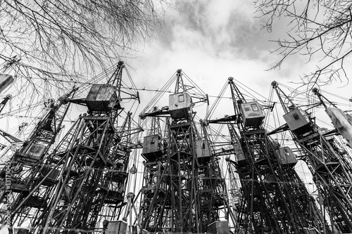 Several old building cranes. Heavy industry. Black and white.