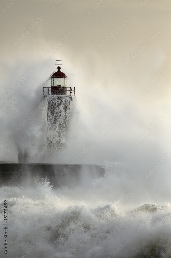 Old lighthouse during heavy ocean storm