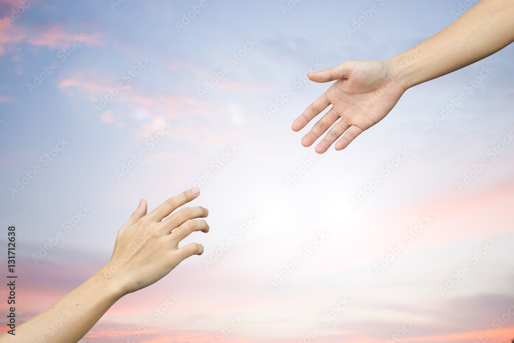 Human hands help together on blur sunset sky backgrounds,forgiveness concept