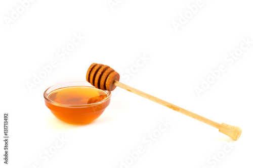Honey in jar or bowl with wooden stick isolated on white background