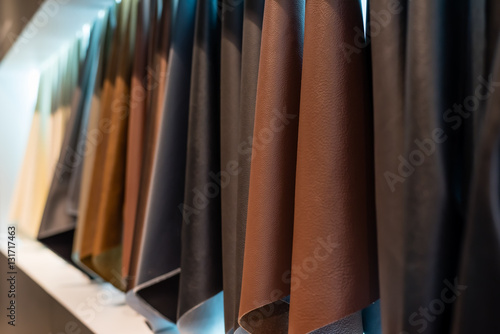 leather and cloth sample hanging on a white wall background