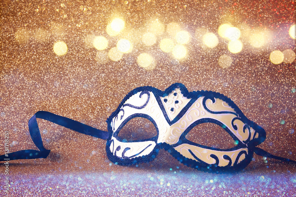 elegant venetian mask on gold glitter background Stock Photo | Adobe Stock