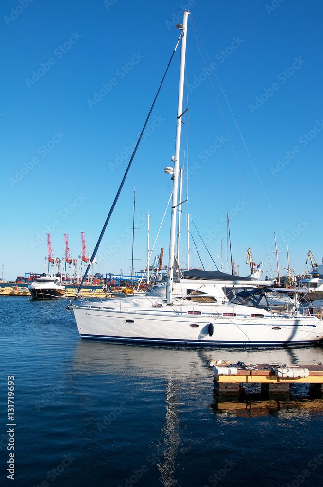 White yachts in the port waiting. On the sea is calm. White yachts in the port waiting. On the sea is calm.