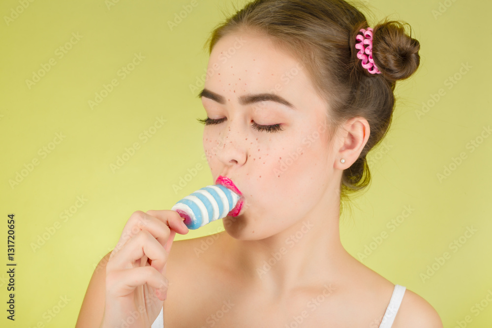 fun girl eats ice cream on yellow background fun girl eats ice cream on yellow background
