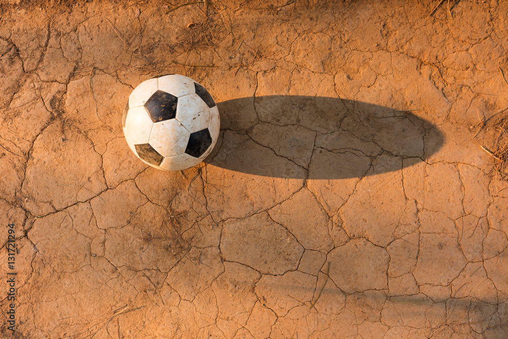 Aged soccer ball on ground