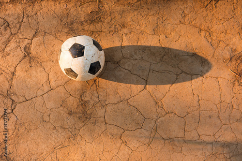 Fototapeta Naklejka Na Ścianę i Meble -  Aged soccer ball on ground