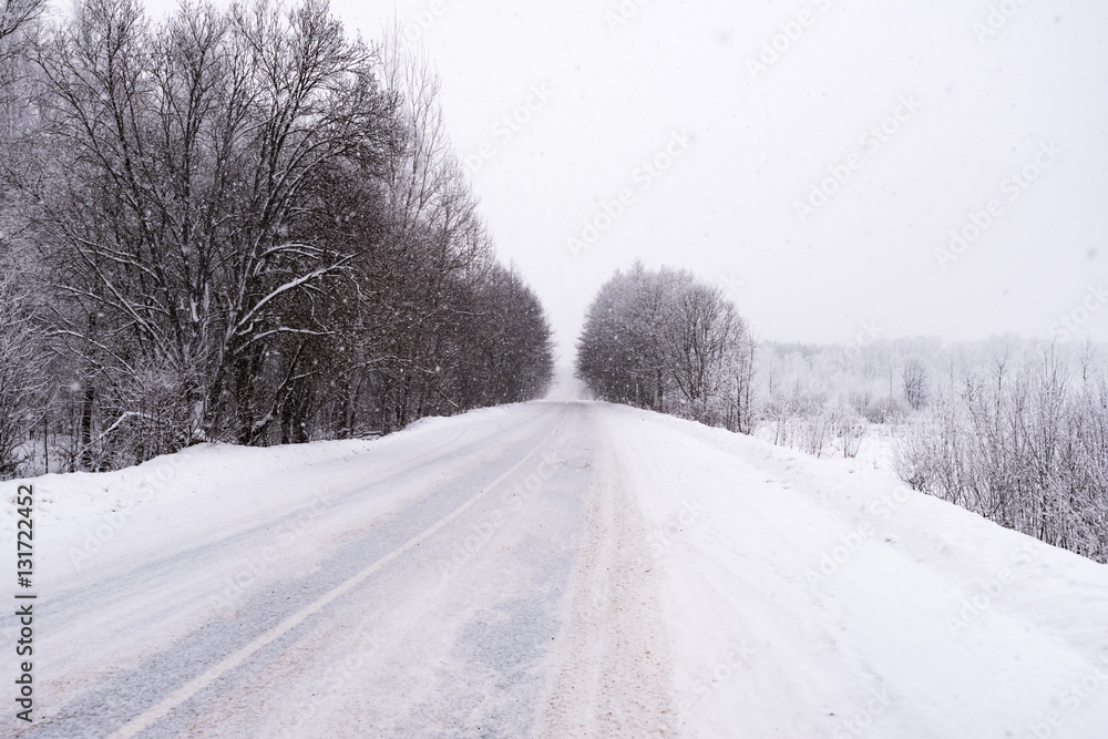 Fototapeta premium winter road in the woods