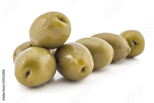 Heap of fresh raw green olives, isolated on white background