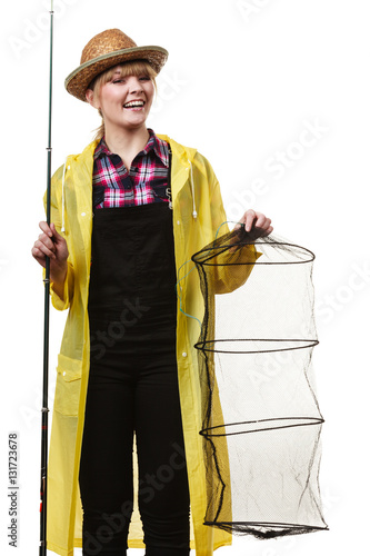 Happy woman holding fishing rod and keepnet photo