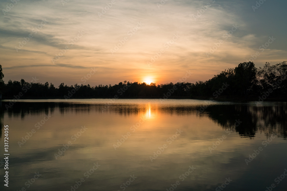 sunset on the river with reflex - reflection in the water surface, Sunset on the lake with trees sillouette