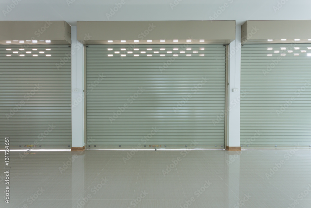 Naklejka premium Aluminium steel metal roller shutter door in warehouse building