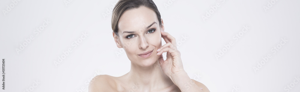 Young woman  touching her face