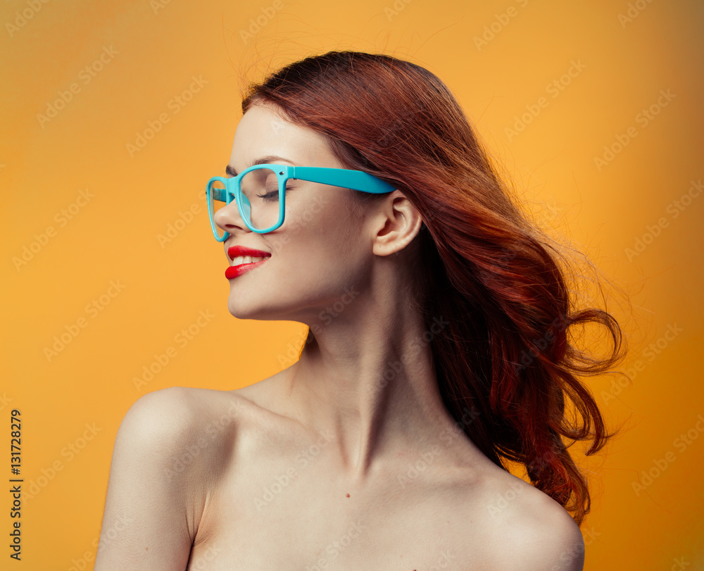 red-haired woman in glasses with a blue rim on a yellow background red-haired woman in glasses with a blue rim on a yellow background