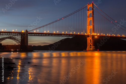 Golden Gate Bridge And Water Reflections. Fort Point, San Francisco, California, USA. The Golden Gate Bridge and the Marin Headlands in the background.