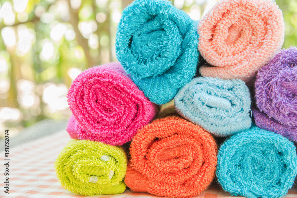 Roll of Multicolor towels on table cloth with nature blur background Roll of Multicolor towels on table cloth with nature blur background