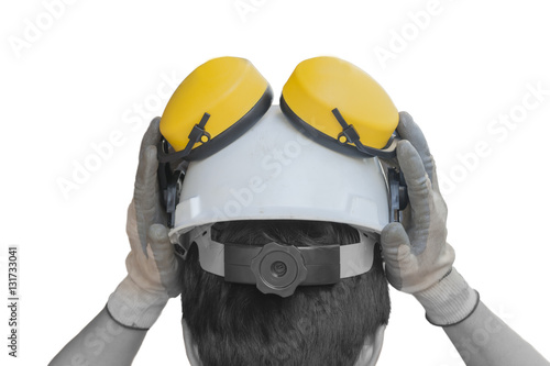 Man pushing safety hetmet with ear protector