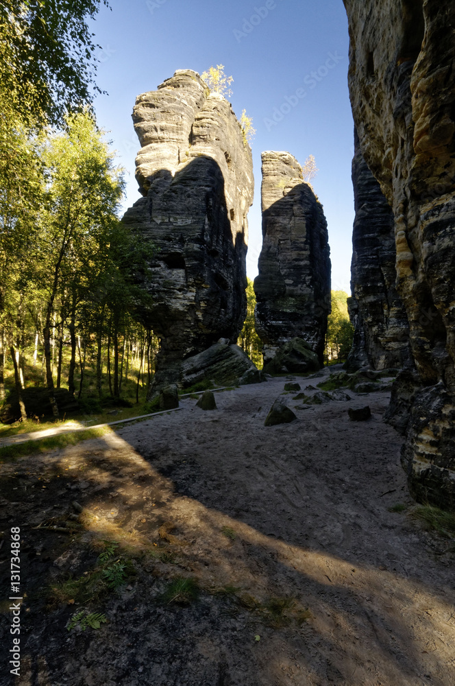 Tall rock formations with a rough terrain in the forefront Tall rock formations with a rough terrain in the forefront