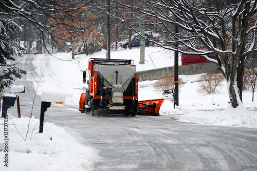 snowplow removing snow on the street after blizzard