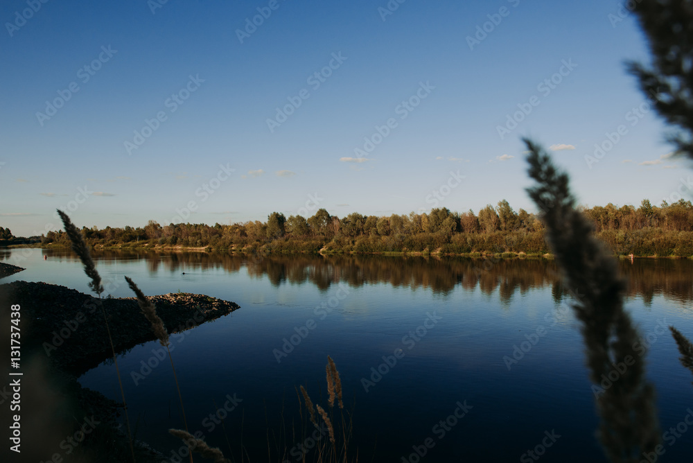 The river with a quiet current and clouds reflected in it, Soz , Gomel, Belarus The river with a quiet current and clouds reflected in it, Soz , Gomel, Belarus