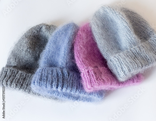 four caps of different colors connected by hand from mohair