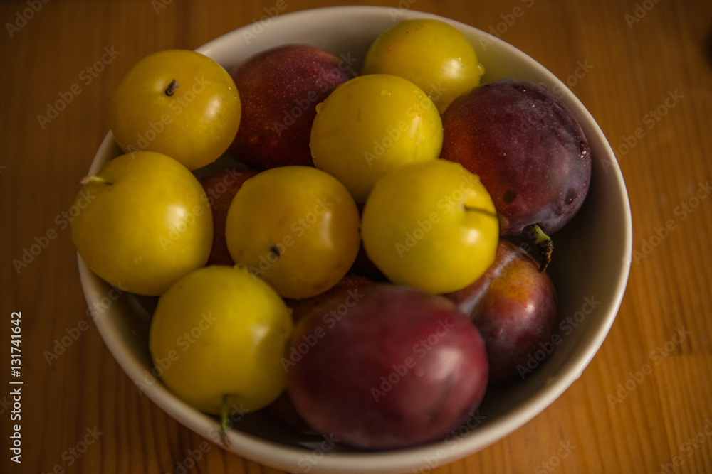 Top view of fresh plums in bowl Top view of fresh plums in bowl
