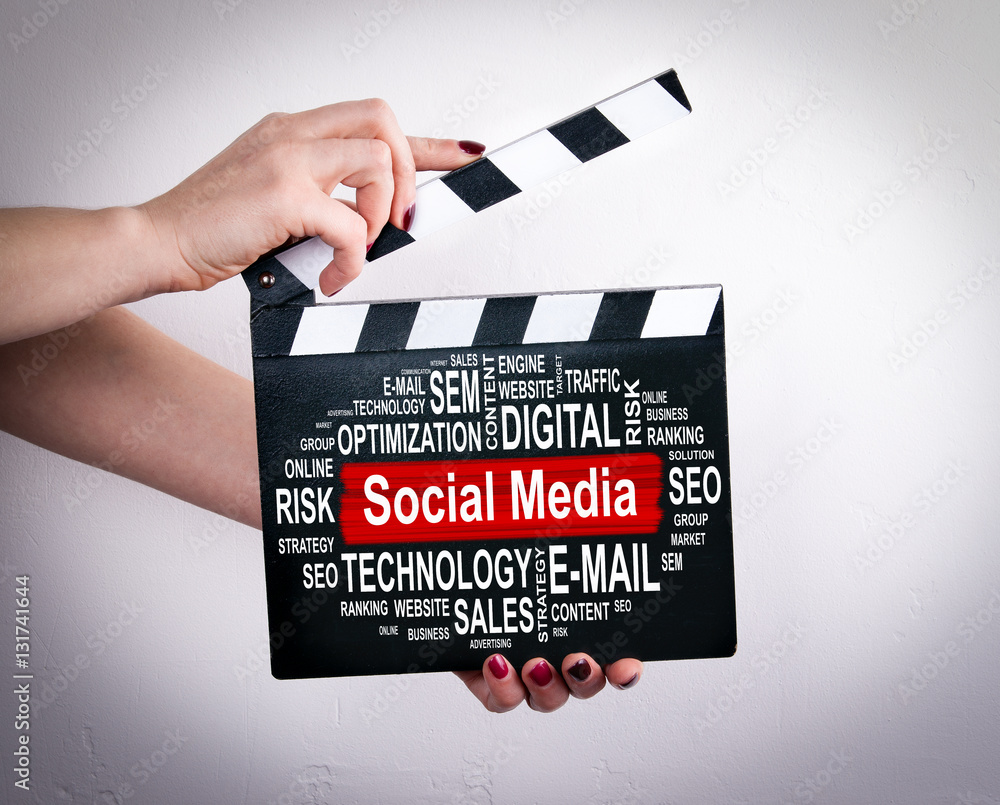 Social Media concept. Female hands holding movie clapper. 