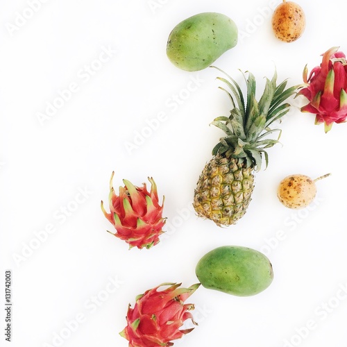 Exotic tropical fruits: mango, pineapple, passion fruit and dragon fruit. Flat lay, top view