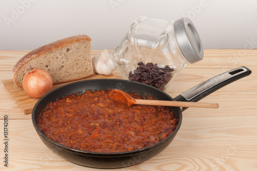 Chili Con Carne in pan on wooden table